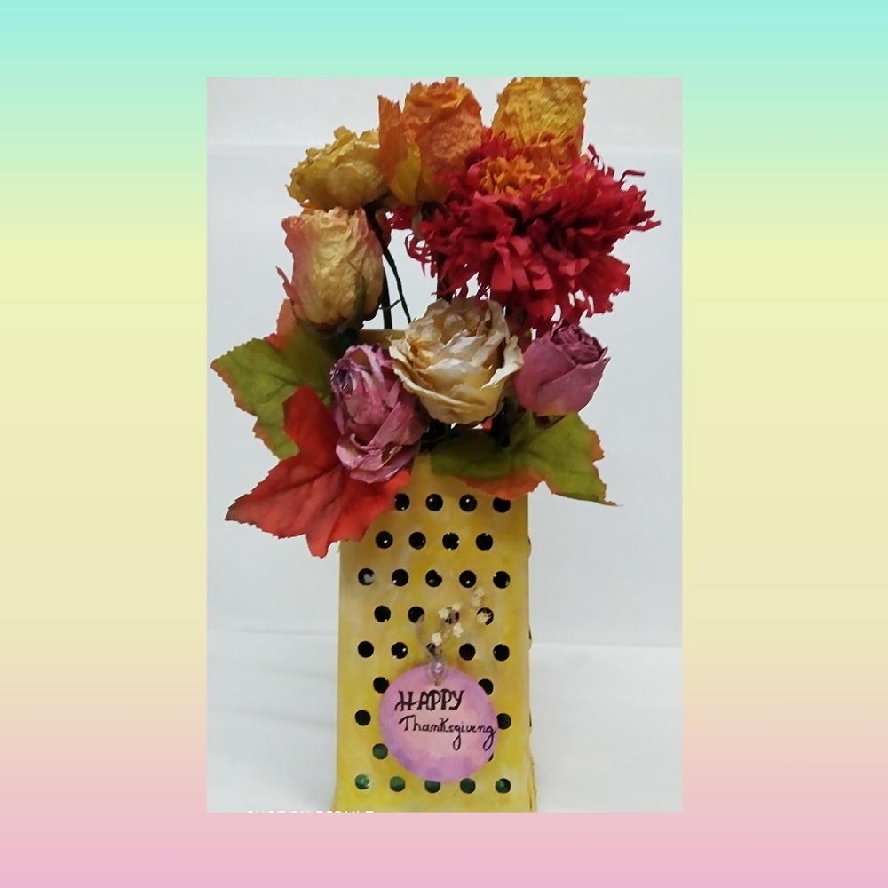 Grater with a bouquet of dried roses